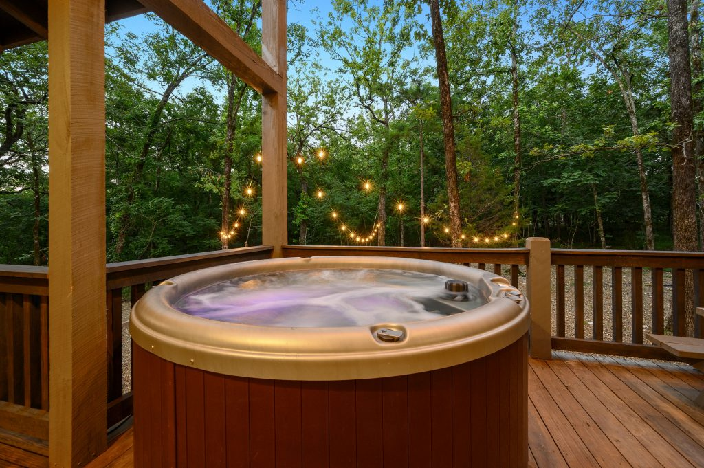 Private hot tub on a deck at a luxury cabin.