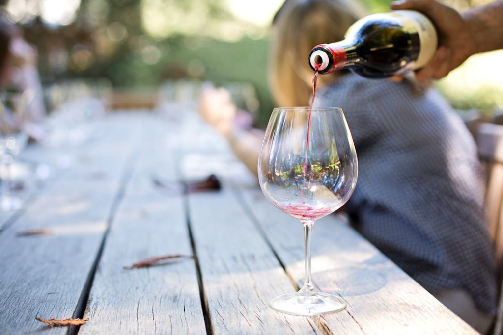 An image of wine being poured into a glass