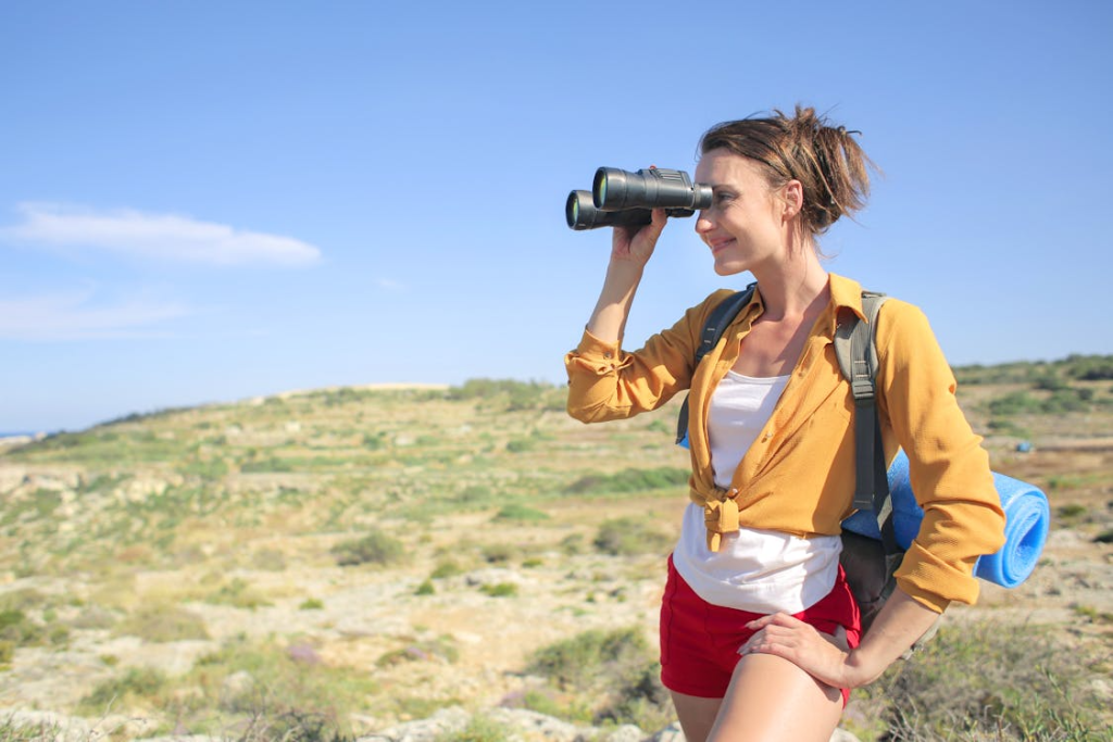 An image of a woman holding up her binoculars