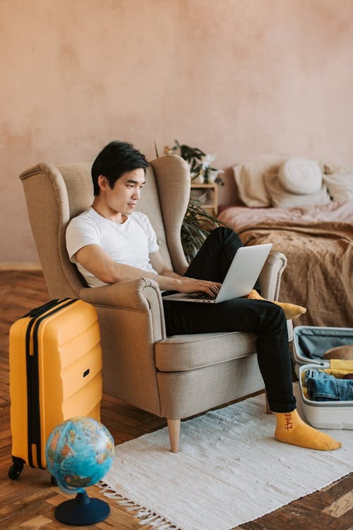 a man in a white shirt sitting on a couch.