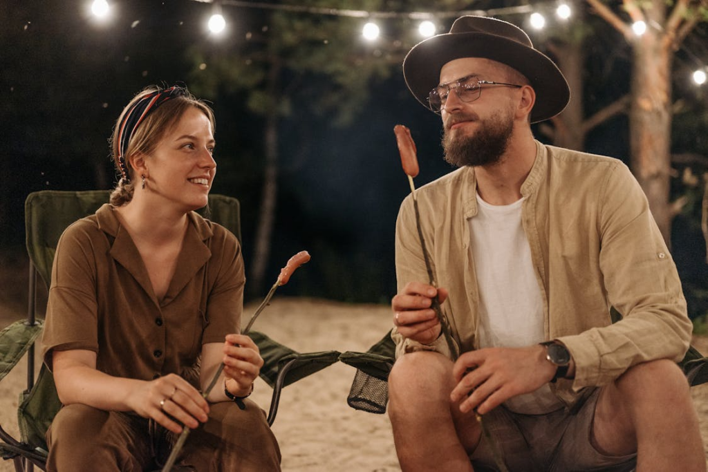 two people sitting outdoors and having a conversation.