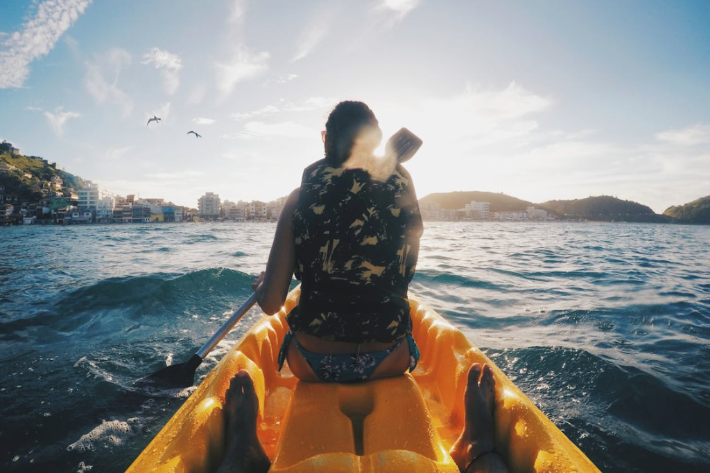 a woman in a vest sitting on a boat.