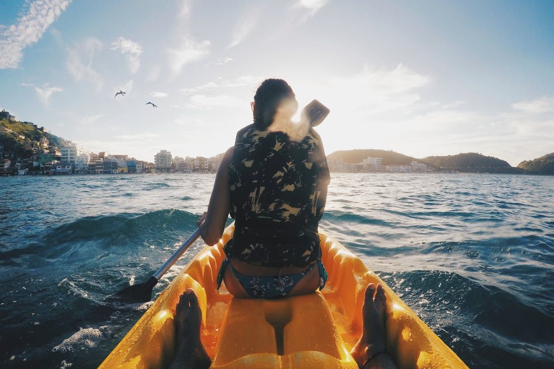 a woman in a vest sitting on a boat.